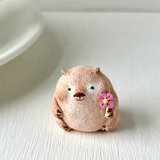 一輪のお花を持つウォンバットさんの画像
