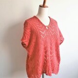 オレンジ色のニットトップス