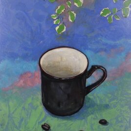 プミラと黒いカップとコーヒー豆の画像