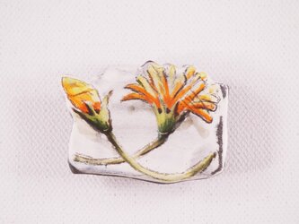 陶器の帯留め-橙色ガーベラの下絵付けの画像