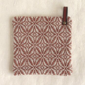 レンガ色模様手織りのポットマットの画像