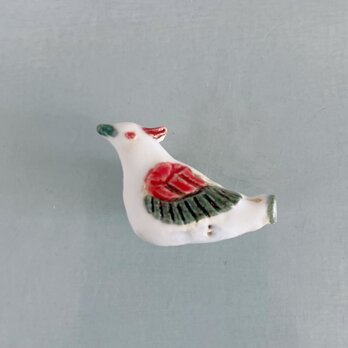 鳥使いの鳥笛［陶器ブローチ］の画像