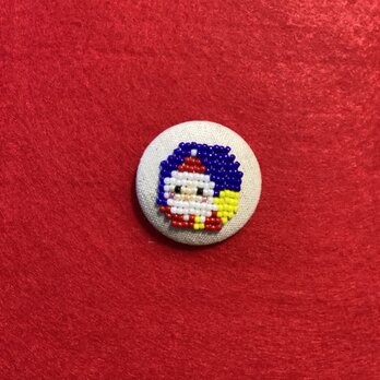 プレゼントの入った袋を背負ったサンタさんのクルミボタン（38mm）の画像