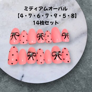 《現品販売》ガーリーなドット×リボンが可愛いピンクブラックネイル｜14枚ミディアムオーバルの画像