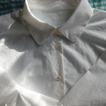 袖タックデザインの白いシャツの画像