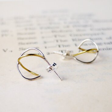 アンフィニティーモチーフのシルバーと黄銅のコンビピアス