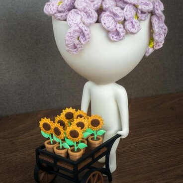 魅力的なロバートプラントポットとひまわりカート