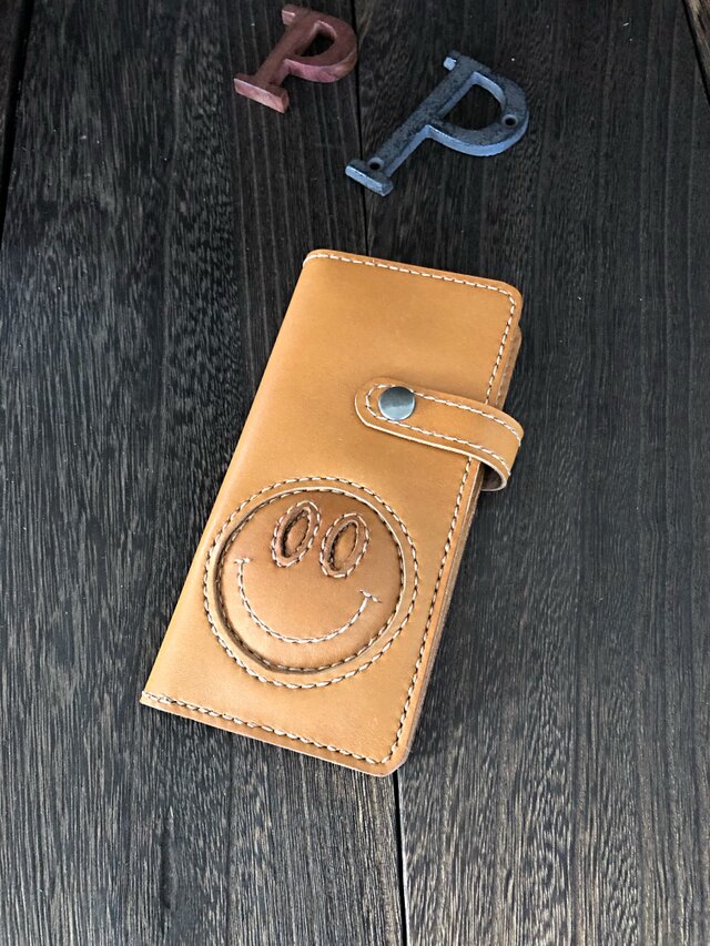 PhoneXS MAXケース(キャメル x ニコちゃん)の画像1枚目