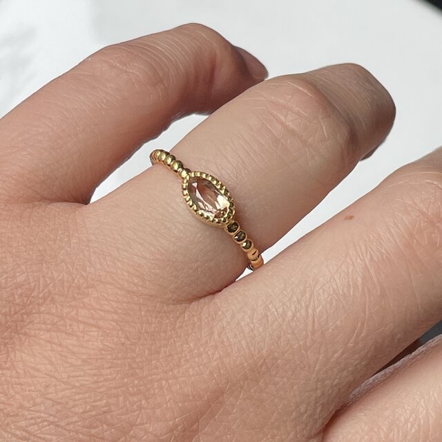 インペリアルトパーズ オーバルカット0.69ct ミル打ちと丸つぶ腕