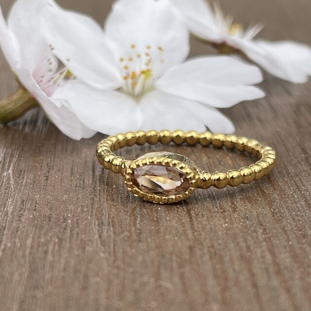 インペリアルトパーズ オーバルカット0.69ct ミル打ちと丸つぶ腕