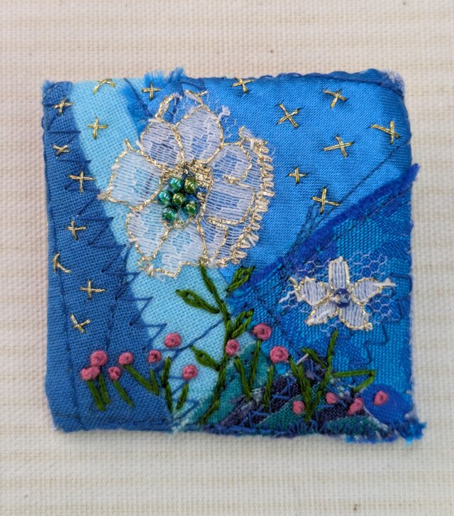 青いコラージュ刺しゅうのブローチ