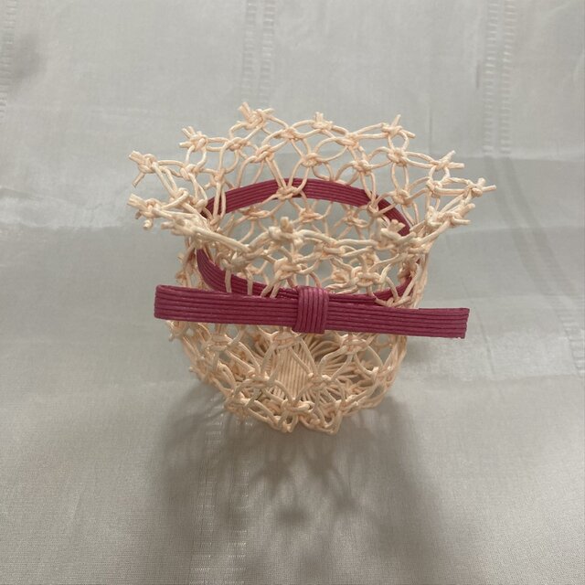 リボンをあしらった優しいピンクのクラフトバンド製小物入れ