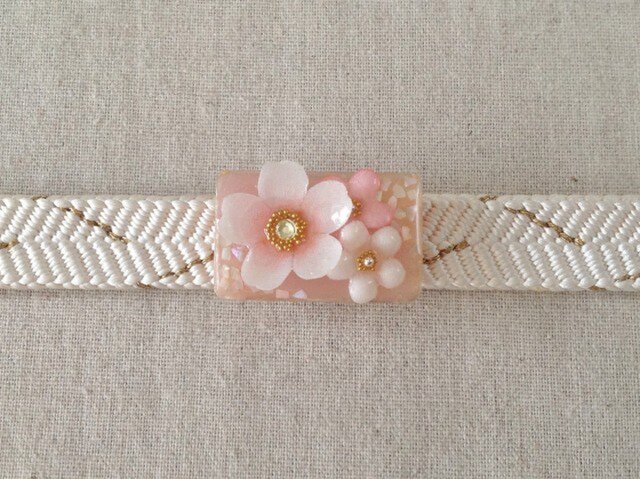 染め花を樹脂加工した桜と小花の帯留め(長方形・白とピンク)の画像1枚目