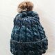 ファーポンポンつき ケーブル編みのツイードニット帽